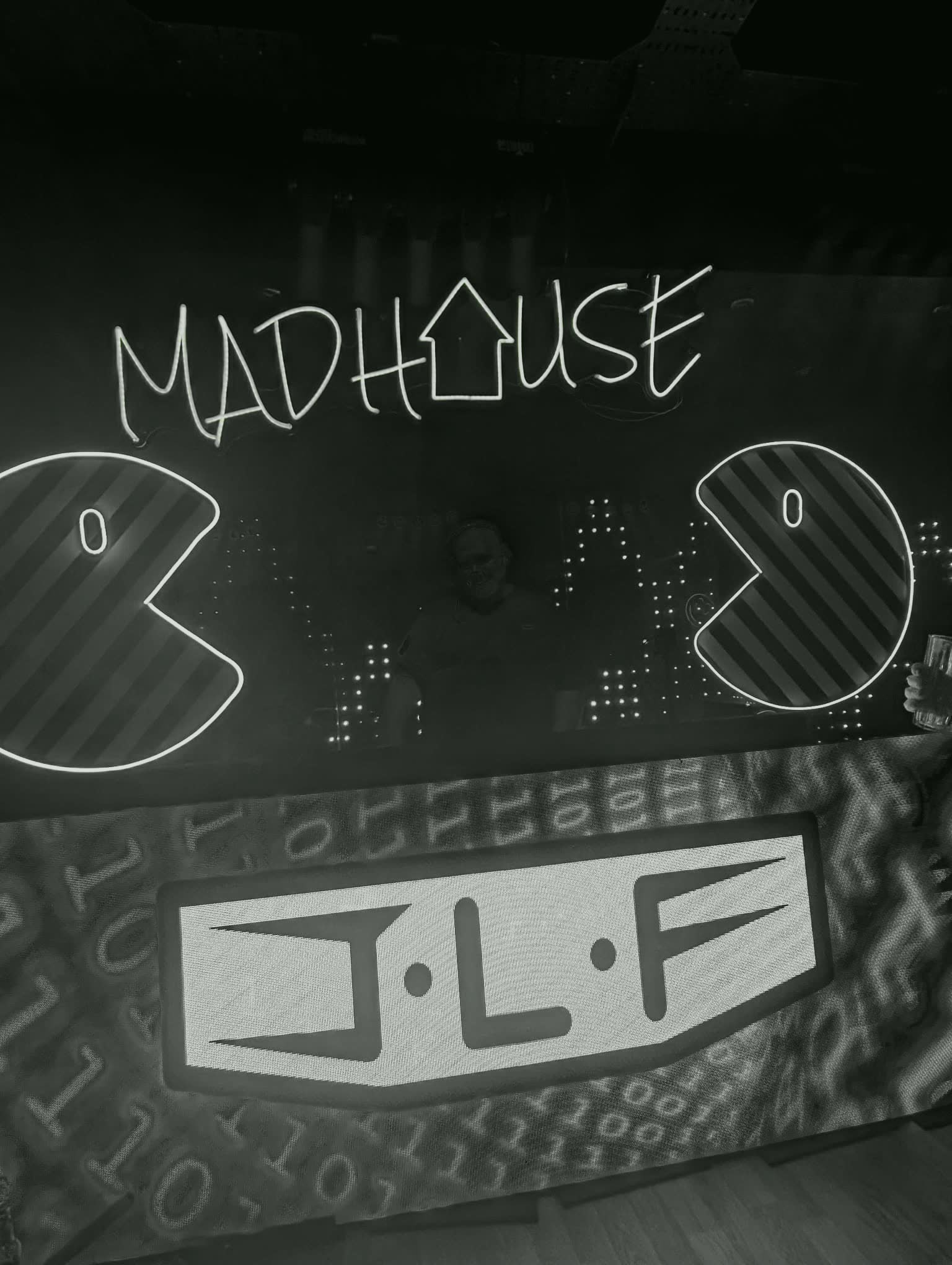 Madhouse neon sign, booth with J L F banner, Club Lexis
